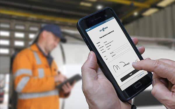 BigChange uses no touch signatures employee holding mobile device
